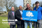 North Manor Councillors, Roger Brown, Khalid Hussain and Liam Dean pose outside with a Conservative sign - with James Daly MP